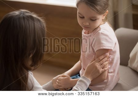 Mom Touch Caress Unhappy Preschooler Daughter Sitting On Couch