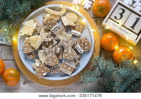 Gingerbread Cookies On A Concrete Tray On A Winter Background With Tangerines, Fir Branches And A Ga