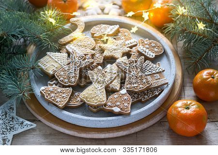 Gingerbread Cookies On A Concrete Tray On A Winter Background With Tangerines, Fir Branches And A Ga