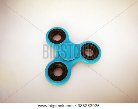 Blue Isolated Spiner Lies On A White Background