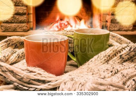 Mugs Of Hot Tea, Wol Scarf Near Cozy Fireplace, In Country House, Winter Vacation.