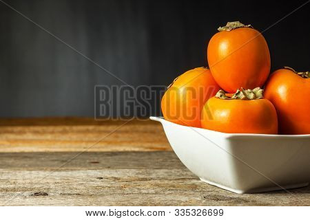 Ripe Orange Persimmon Fruit.kaki Fruit On Wooden Table.slices Of Persimmon.set Of Kakis. Fruits Of K