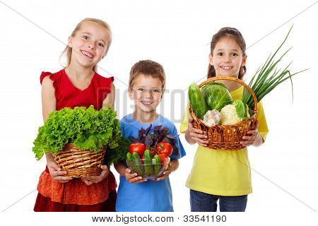 Smiling kids with fresh vegetables