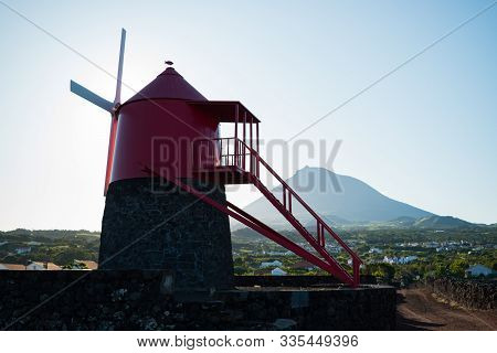 Moinho Do Frade, Pico Island, Azores - September 11 2019: A Restored Traditional Red Windmill Silhou