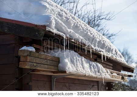 Snow Load On Roof Of A Wooden House In The Garden - Close-up Of Garden Hut