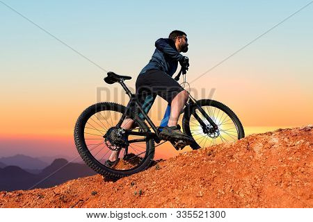 Cyclist In Shorts And Jersey On A Modern Carbon Hardtail Bike With An Air Suspension Fork Rides Off-