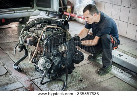 Removed Engine From Car. Auto Mechanic Repairs Car Engine