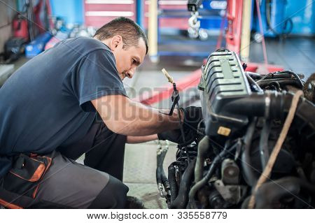 Removed Engine From Car. Auto Mechanic Repairs Car Engine