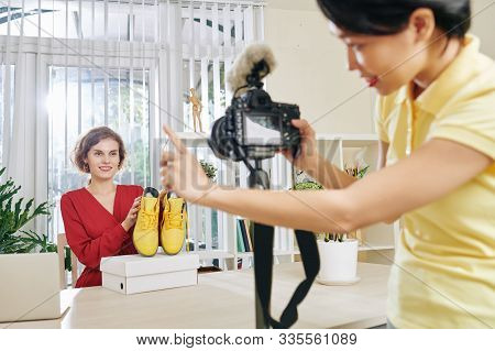 Pretty Smiling Fashion Blogger Waiting For Signal From Her Camerawoman To Start Talking About New Sh