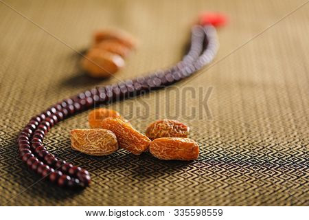 Date Fruits With An Islamic Prayer Beads On An Artistic Background. Beautiful Background For Ramzan 