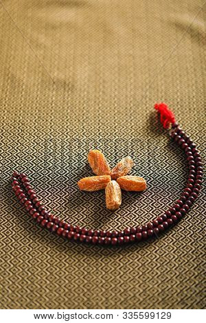 Date Fruits With An Islamic Prayer Beads On An Artistic Background. Beautiful Background For Ramzan 