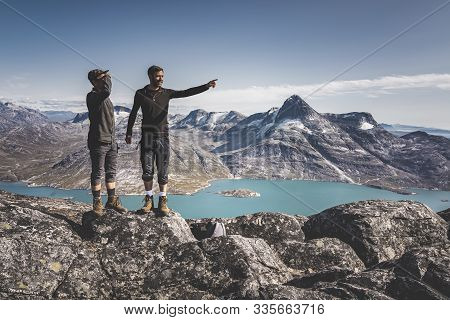 Two Young Man Happy Traveler On Top Of Mountain In Greenland, Nuuk. Nature Mountain Landscape Aerial