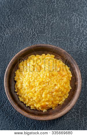 Portion Of Pumpkin Risotto On Wooden Background: Top View
