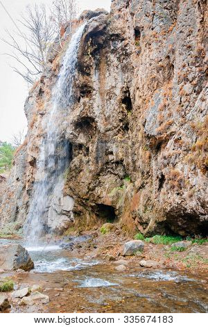 High Waterfall. Autumn Landscape With A River And Rocky Terrain. Honey Waterfalls, A Tourist Place I