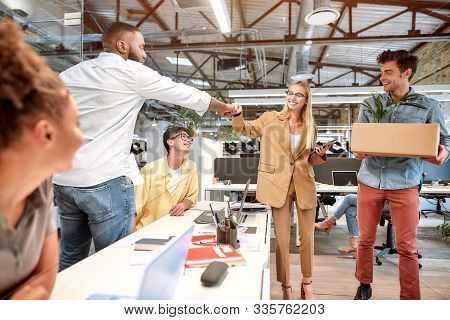Nice To Meet You. Young Beautiful Woman In Suit Giving Fist Bump To Her New Coworker While Standing 
