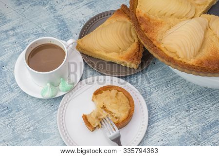 Delicious Home Bake Poached Pear Tart Pie, As Known As Tarte Bourdaloue, A Cup Of Coffee Latte. It I