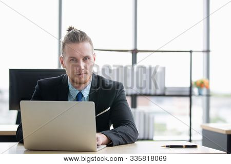 Portrait Shot Of Handsome Caucasian Businessman Using Notebook Computer In The Modern Office Activel