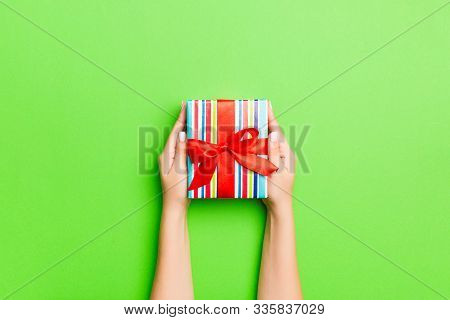 Top View Of Female Hands Holding Christmas Or Other Holiday Handmade Present Box Package In The Palm