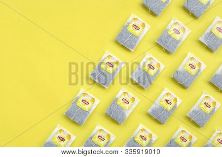 Flat Lay Of Lipton Yellow Label Black Tea Bags On Pastel Yellow Surface. Lipton Is A World Famous Br