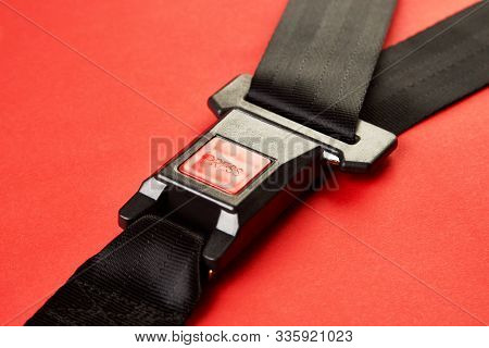 Fastened Seat Belt On Red Background With Copy Space, Close-up
