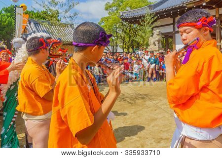 Himeji, Japan - October 14, 2019: Men In Traditional Dressing Play Flute, And Crowd. Part Of The Nad