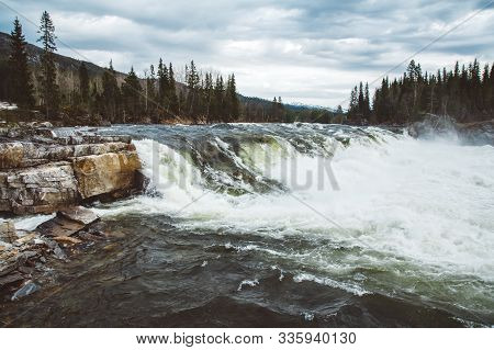 Waves And Splashes Of Mountain River On Background Of Forest And Dramatic Sky. Forest River Water La
