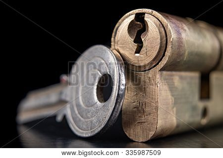 A Old Door Lock On A Dark Background. A Patent And Keys To Secure The Front Door.