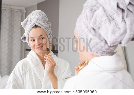 Dermaroller. Woman Is Making Procedure On Face With Meso Roller In Home