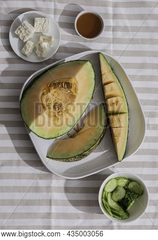 Fresh Melons Sliced On Tablecloth. Free Space For Text. Melon Sliced Of Japanese Melons, Honey Melon