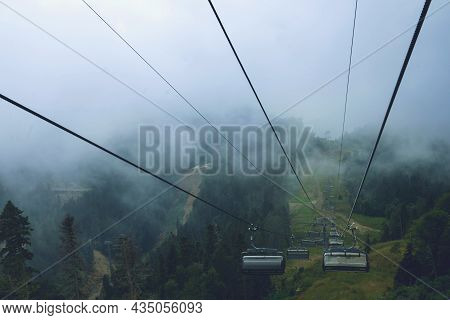 Cable Car In The Mountains With Clouds Or Fog.view From The Cable Car To The Mountain Landscape.the
