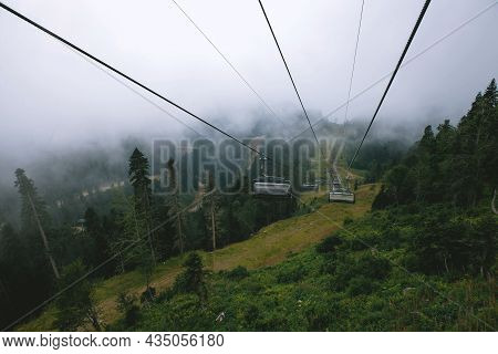 Majestic View Of The Beautiful Misty Mountains In A Misty Landscape. A Dramatic Unusual Scene. Trave