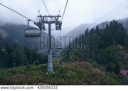 Cable Car In The Mountains With Clouds Or Fog.view From The Cable Car To The Mountain Landscape.the