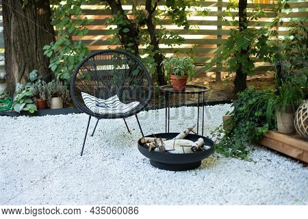 Front Veranda Of House With Black Acapulco Armchairs, Coffee Table And Plants Pots. Metal Black Fire