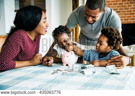 Family saving money in a piggy bank