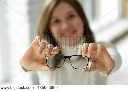 Woman With Poor Eyesight. A Beautiful Girl Wears Glasses To Improve Her Vision. High Quality Photo