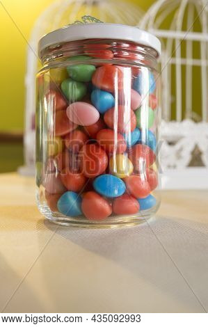 Colorful Candied Sweets Pebbels, Displayed In Glass Jar. Selective Focus