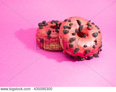 Red Cronuts On A Pink Background. High Quality Photo