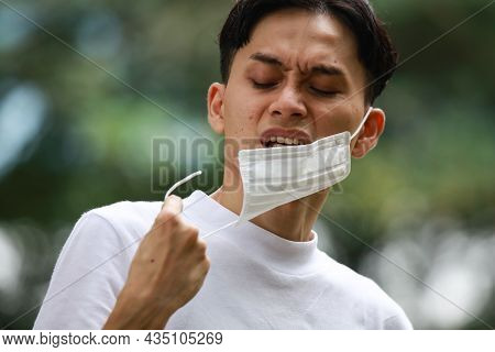 Image Of A Man With A Broken Mask