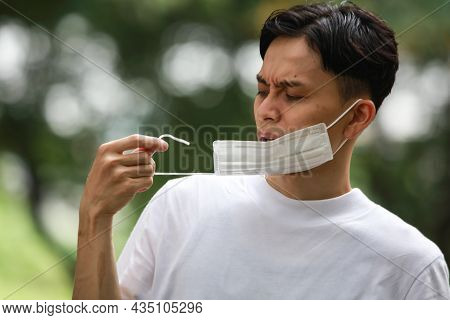 Image Of A Man With A Broken Mask