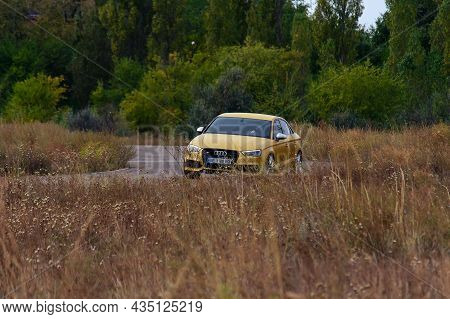 A Sporty Yellow Sedan Drives At High Speed On An Autumn Paved Road. Audi Rs3 Sportback Quattro Car. 