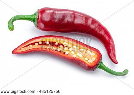 Fresh red chilli pepper and cross section of chilli pepper with seeds isolated on white background.