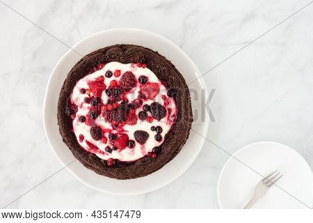 Chocolate Cloud Cake, Flourless, With Creme Fraiche And Frozen Summer Berries On Marble Background. 