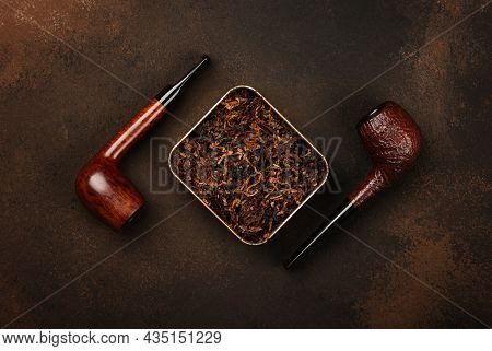 Close Up Tin Full Of Ready Rubbed Long Coarse Cut Tobacco Blend And Two Handmade Briar Smoking Pipes