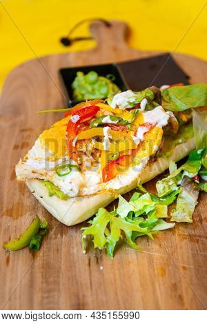 Whole-meal bread sandwich topped with Lyon rosette and butter