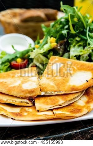 Delicious Mexican beef quesadillas with fresh lettuce and guacamole sauce