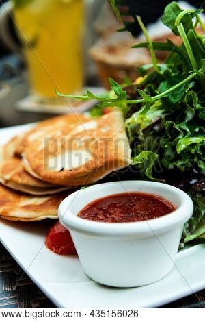 Delicious Mexican beef quesadillas with fresh lettuce and guacamole sauce