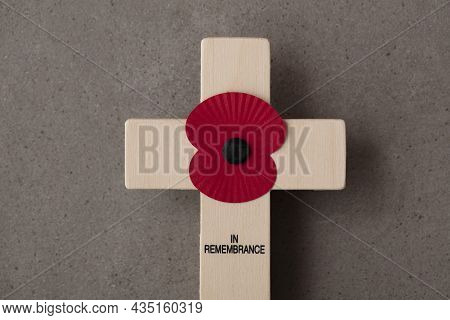 A Red Remembrance Poppy On A Wooden Cross. Military Remembrance Day Concept