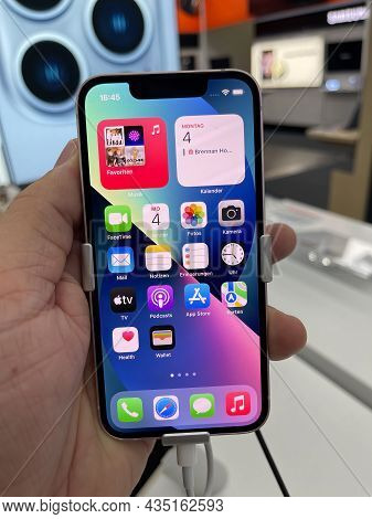 Frankfurt, Germany - October 04th 2021: A German Photographer Comparing And Testing The New Iphone 1