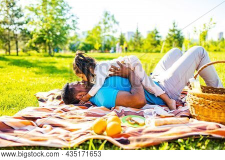 Latin Hispanic Man With Cute Baby Celebrating Fathers Day At Picnic In Sunny Park