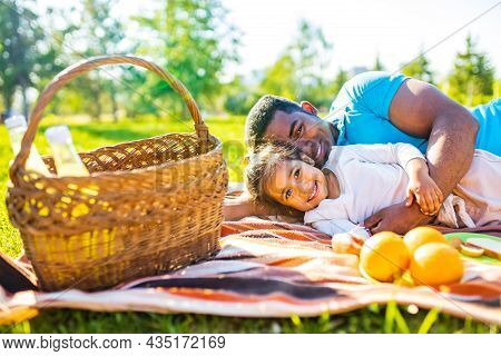 Latin Hispanic Man With Cute Baby Celebrating Fathers Day At Picnic In Sunny Park